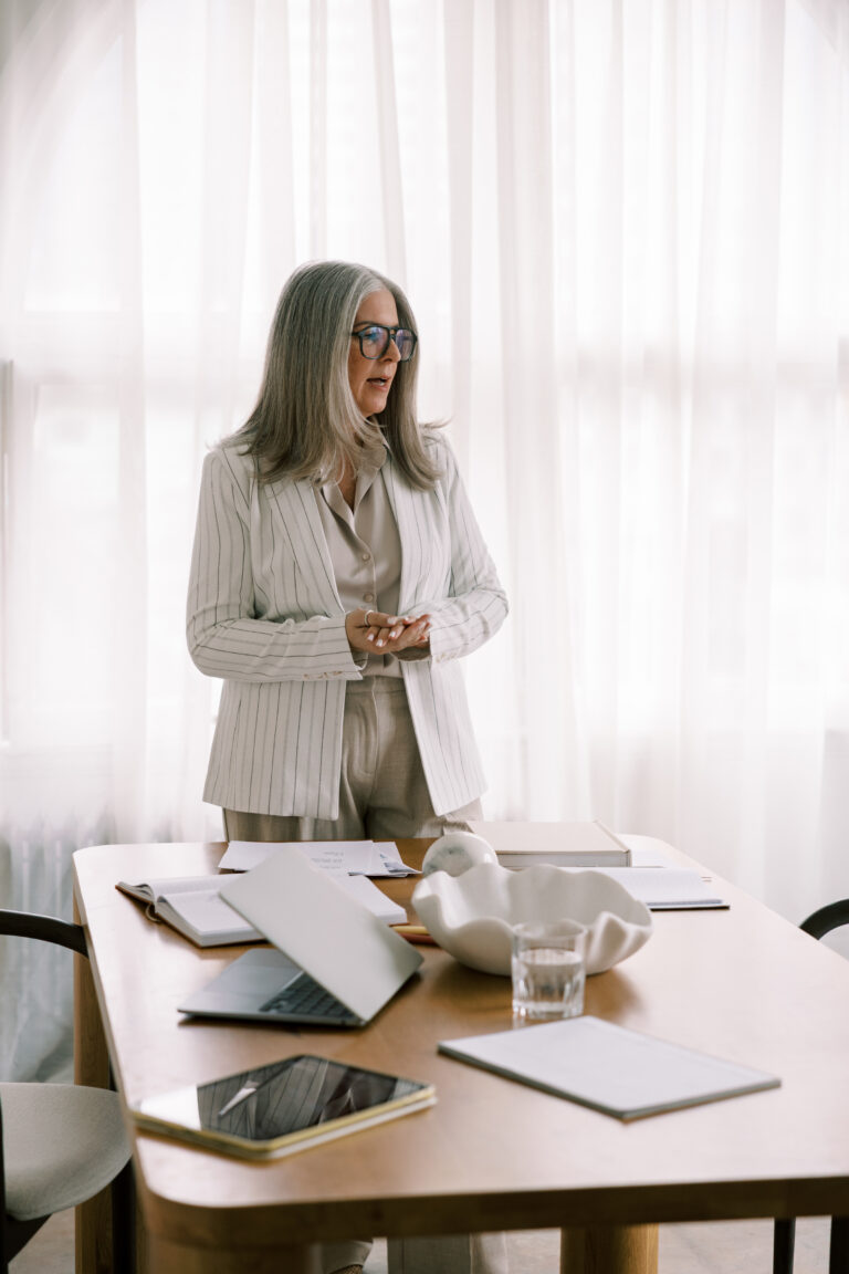 Female board member stands at desk. What decisions require nonprofit board approval?